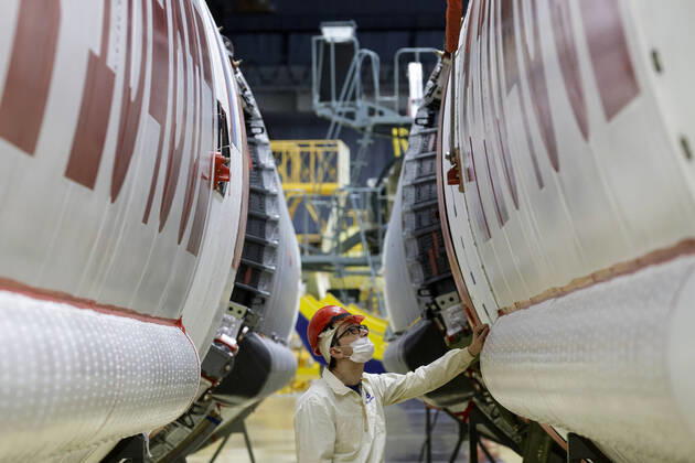 MOSCOW, RUSSIA - FEBRUARY 22, 2022: An employee prepares a Proton-M heavy-lift launch vehicle for departure from Khrunichev State Research and Production Space Centre to the Baikonur Cosmodrome as part of the joint ESA (European Space Agency) and Roscosmos mission ExoMars 2022, including also the Kazachok lander and the Rosalind Franklin rover. Mikhail Japaridze TASS  TS124E8D