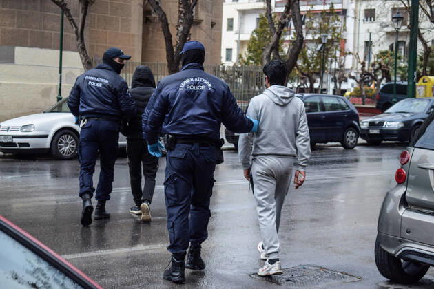 Greek Police detain irregular migrants without legal documents Greek Police officers detain irregular migrants without legal residence permit in the Aghios Panteleimonas area in central Athens, a district with high immigrant population. Athens Greece Copyright: DimitrisxAspiotis