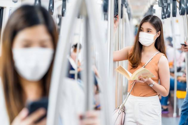 Young Asian woman passenger wearing surgical mask and reading the book in subway train when traveling in big city at Covid19 outbreak, Infection and Pandemic concept, model released, , property released, , 33549576.jpg, avoid sick, train station, virus outbreak, tourist travel, subway train, 2020, bangkok thailand, respiratory, quarantine, protection, face, bts skytrain, environment, social distancing, crowned people, new normal, young woman, asian, business, cellphone, chinese, city, female, japanese, korean, china, metro, passenger, public, smartphone, southeast asian, transport, urban, commuting, journey, teenager, business on the go, earphone, covid19, coronavirus, 2019-ncov, disease, influenza, pandemic, air pollution, surgical mask, h