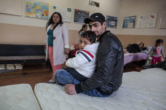 April 8, 2022, Chisinau, Moldova: Roma man hugs his son inside the room where they take refuge after fleeing the conflict in Ukraine. The Roma people romanies, also known as gypsies are part of the 4 million people that have been displaced by violence from the armed conflict in Ukraine; placed in refugee aid centers in different parts of Moldova. They are generally organized and separated from other groups..There is no precise data, but according to organizations such as the Fundacion Secretariado Gitano, there are about 400,000 Romas living in Ukraine. Chisinau Moldova - ZUMAs197 20220408_zab_s197_062 Copyright: xIsraelxFuguemannx
