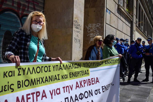 Greece: Thousands take to Athens streets in protest of price hikes A woman protests in front of the Ministry Of Development holding banner with slogans against soaring unbearable prices that plague Greek society. Athens Greece Copyright: DimitrisxAspiotis