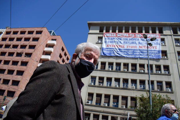 Greece: Thousands take to Athens streets in protest of price hikes Activists hang a giant banner in the facade of the Ministry of Development with slogans against price hikes while thousands protest in the streets. Athens Greece Copyright: DimitrisxAspiotis