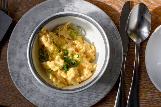 The portion of scrambled eggs, arranged in a bowl, stands on a breakfast table in a hotel in Schleswig Photo Winfried Rothermel