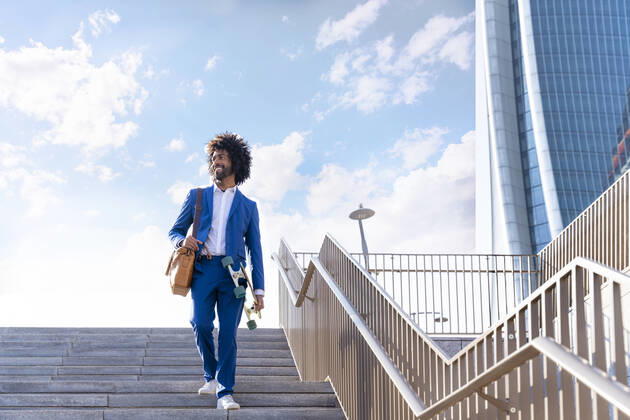 Smiling businessman with skateboard walking down on staircase model released, Symbolfoto, OIPF01457