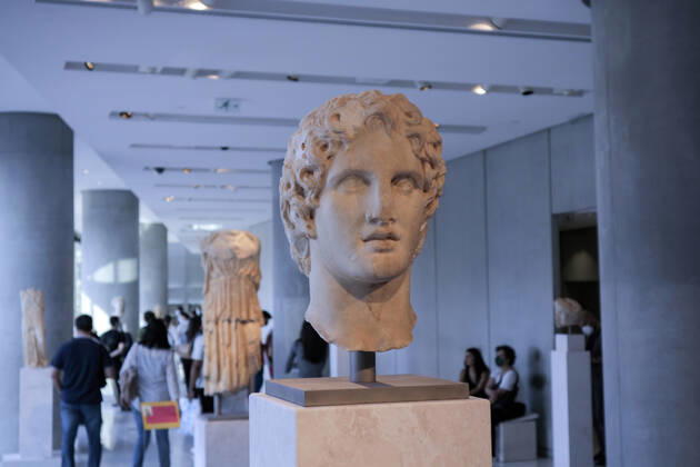 Tourists and locals visit the Acropolis Museum in Athens during International Museum Day Visistors pass by the head of a statue of Alexander the Great in the Acropolis Museum. Tourists and locals visit the Acropolis Museum in Athens and enjoy free entrance as part of the celebrations on International Museum Day. Athens Greece Copyright: DimitrisxAspiotis