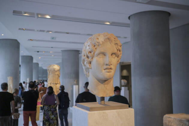Tourists and locals visit the Acropolis Museum in Athens during International Museum Day Visistors pass by the head of a statue of Alexander the Great in the Acropolis Museum. Tourists and locals visit the Acropolis Museum in Athens and enjoy free entrance as part of the celebrations on International Museum Day. Athens Greece Copyright: DimitrisxAspiotis