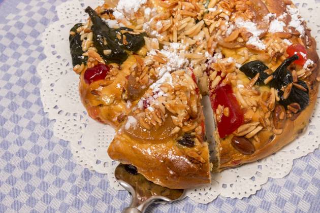 Portuguese King Cake is a famous christmas celebration cake with dry nuts and crystalized fruits. , 25769748.jpg, almond, background, baked, bakery, cake, christmas, colorful, crystallized, cuisine, dry, fig, fluffy, food, fruit, gastronomy, glace, grape, icing, isolated, king, nut, pastry, pine, pinea, pinus, portugal, portuguese, raisin, round, seasonal, seed, sugar, sweet, tasty, top, tradition, traditional, typical, view, white, xmas, cloth, table,