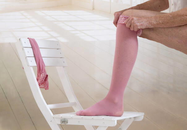 Woman putting thrombosis stockings on , 19650760.jpg, Anti, Bed, Bedroom, Pharmacist, Shelf, aching, adult, ankle, antithrombotic, arteries, background, bandage, beige, care, caucasian, clinic, compress, compression, compressive, difficulties, disease, doctor, dvt, edema, elastic, female, foot, hands, health, healthcare, heart, isolated, leg, lifestyle, limbs, lymph, lymphedema, medical, medicine, nodes, nursing, pharmacy, pressure, prosthesis, pull, retail, sick, stock, stocking, stockings, stool, store, studio, supplies, tedious, thrombosis, tighten, treatment, varicose, varicosis, veins, vertical, water, white, young,