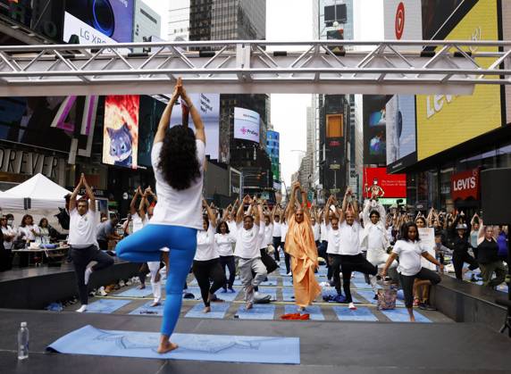 People attend a yoga class at the 20th Anniversary celebration of the Summer Solstice in Times Square: Mind Over Madness Yoga, an annual all-day outdoor yoga event, in New York City on Tuesday, June 21, 2022.  NYP20220621105 JohnxAngelillo