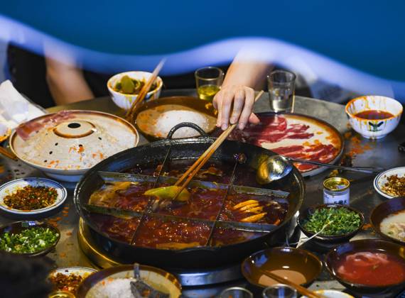 (220703) -- CHONGQING, July 3, 2022 -- People enjoy a meal at a hot pot restaurant at a commercial street in southwest China s Chongqing Municipality, June 5, 2022. Under COVID-19 prevention and control measures, Chongqing in southwest China has striven to combine its night economy with culture and tourism in innovative ways, thus enhancing the vitality and attraction of nighttime consumption and turbocharging its development. ) CHINA-CHONGQING-NIGHT ECONOMY (CN) WangxQuanchao 