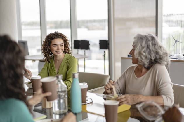 Happy senior businesswoman having snacks with coworkers model released, Symbolfoto property released, JCICF00150