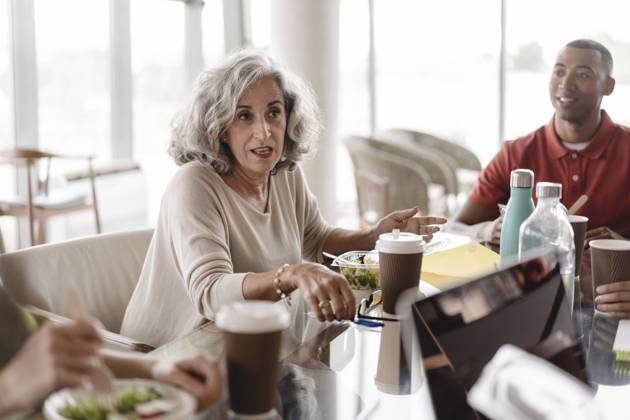 Senior businesswoman sitting with businessman discussing at table in office model released, Symbolfoto property released, JCICF00151
