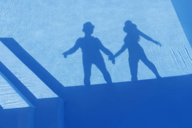Shadow of couple holding hands seen on water of swimming pool model released, Symbolfoto property released, MAEF13074
