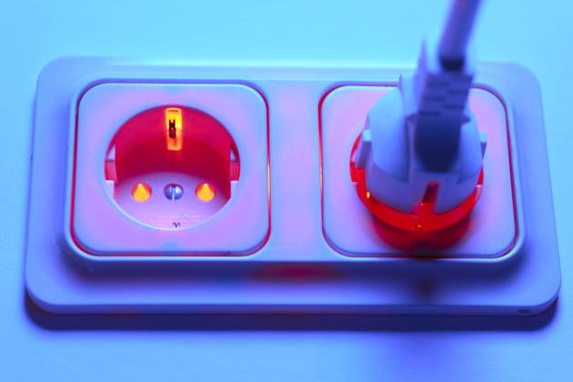 Threat of overloading the power grid in winter by connecting too many fan heaters Red lighted socket with Schuko plug Energy prices electricity, Bonn, Germany on 28 08 2022
