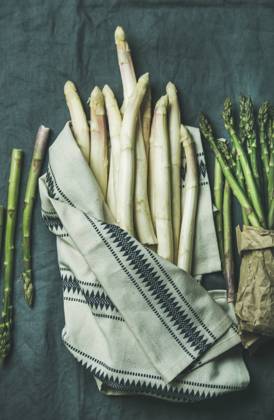 Fresh green and white asparagus in towel over dark grey linen table cloth background Fresh green and white asparagus in towel over dark grey linen table cloth background, top view Copyright: xAnnaxIvanovax AI200417-20