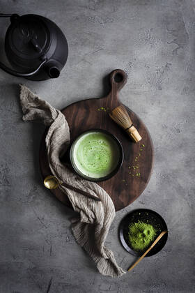 Matcha tea with a kettle and whisk on a dark surface Matcha tea with a kettle and whisk on a dark surface Copyright: xHeidixRichterx HR030621-21