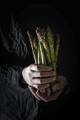 Bundle of green asparagus Bundle of raw organic green asparagus in dirty man s hand in black shirt. Copyright: xNatashaxBreenx NB080519-8