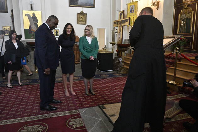 U.S. Secretary of Defense Lloyd Austin, left, Czech Defence Minister Jana Cernochova, right, pay homage to the Czechoslovak paratroopers who killed Nazi Deputy Reichsprotector Reinhard Heydrich, Friday, Sept. 9, 2022, the Saint Cyril and Methodius Church, Prague, Czech Republic. At center is mayor of Prague 2 Alexandra Udzenija. (CTKxPhoto VitxSimanek) CTKPhotoP2022090903047