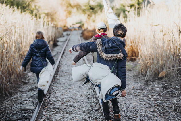 Back view of unrecognizable group of three children hiking in the woods walking in a train track, Model released JoseLuisCarrascosa_AdventureBoys_4 Copyright: xJosexLuisxCarrascosax MR