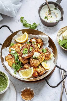 A serving platter with curried indian mashed potatoes, garnished with coriander leaves and lemon A serving platter with curried indian mashed potatoes, garnished with coriander leaves and lemon Copyright: xSandhyaxHariharanx SH210122-25