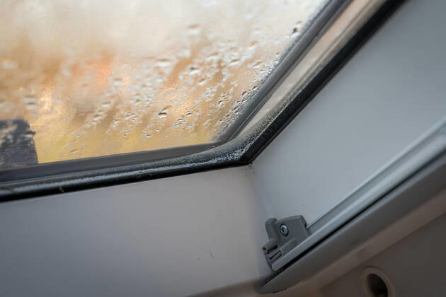 Germany, Bavaria - 31 October 2022: Fogged skylight in the morning. Water drops from condensation on a window