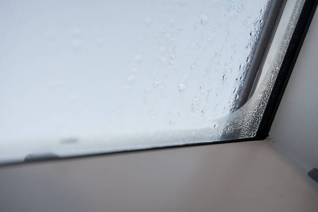 Germany, Bavaria - 31 October 2022: Fogged skylight in the morning. Water drops from condensation on a window