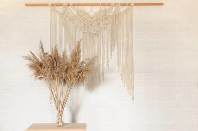 RECORD DATE NOT STATED Beige reed against a white wall with a macrame wall panel. A minimal, stylish, trendy concept with a beautiful background with light neutral colors. , 35135524.jpg, art, background, beige, beige background, bohemian, boho, cozy, craft, decor, decoration, decorative, design, eco, female, floral, flower, hand, handmade, hobby, home, house, interior, knit, knot, lifestyle, living, macrame, macramo , minimalism, ornament, pastel, pattern, plant, room, rope, rustic, scandinavian, still, style, table, texture, tradition, traditional, vintage, wall, wall art, wall hanging, wall hangings, white, yellow