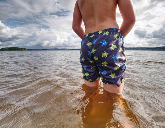 RECORD DATE NOT STATED Little joyful Caucasian funny boy try cold water of lake. Kid stay in water with level at knee, model released, , 36931044.jpg, boy, caucasian, cheer, child, childhood, cold water, cold weather, cooling, cowards, droplet, dynamic, enthusiasm, expression, floundering, happiness, hard, holiday, hot, joy, kid, knee, lad, lake, laughing, lonely, low angle view, low view, natural, play, pond, poor, rest, river, sand, scenic, seashore, smile, son, splash, summer, summertime, sunbeam, swim, swimmer, swimming pants, swimming shorts, swimming suit, try, vitality, water