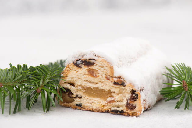 Christstollen, traditonal christmas cake with nuts, raisons, marzipan on a blue background, empty Christstollen, traditonal christmas cake with nuts, raisons, marzipan on a blue background, empty space for text Copyright: xZoonar.com BeritxKesslerx 18596391