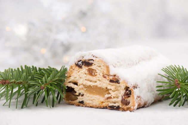 Christstollen, traditonal christmas cake with nuts, raisons, marzipan on a blue background, empty Christstollen, traditonal christmas cake with nuts, raisons, marzipan on a blue background, empty space for text Copyright: xZoonar.com BeritxKesslerx 18596394