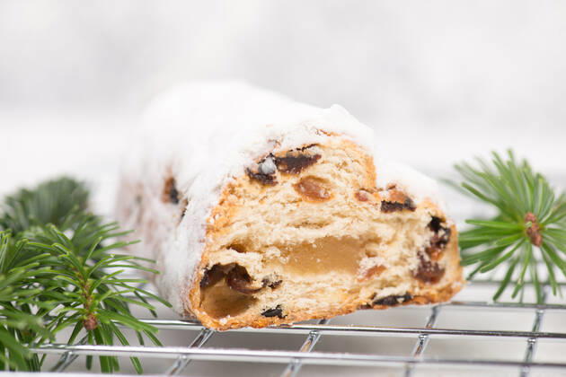 Christstollen, traditonal christmas cake with nuts, raisons, marzipan on a blue background, empty Christstollen, traditonal christmas cake with nuts, raisons, marzipan on a blue background, empty space for text Copyright: xZoonar.com BeritxKesslerx 18596415