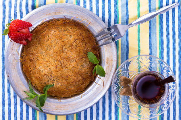 IMAGO Creative, Food, Künefe RECORD DATE NOT STATED Turkish dessert kunefe isolated on a picnic cloth with mints and sliced strawberry along with Turkish hot tea , 9359466.jpg, Dough, Food, Freshness, Ingredient, Macro, Plate, appetizer, arabic, bakery, baking, butter, cheese, cloth, cooking, cuisine, delicious, dessert, dinner, east, ethnic, fillo, fork, golden, gourmet, greek, hatay, hot, isolated, kadaifi, kadayif, kanafeh, kataifi, kunafeh, kunefe, leaves, lebanese, lunch, meal, mediterranean, mersin, middle eastern, mint, pastry, restaurant, shredded, strawberry, sweet, syrup, table, tea, traditional, turkish,
