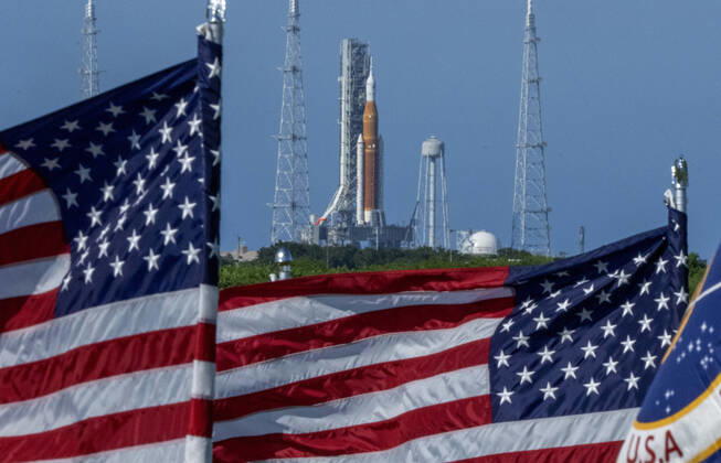 Artemis 1 is framed by American Flags as it sits on the Launch Pad 39B on August 30, 2022, shortly before it was announced that NASA plans to launch the moon mission on Saturday, September 3, 2022, at Kennedy Space Center, Florida. The mission was scrubbed on Monday due to an engine issue. NASA s SLS rocket with the Orion capsule atop is the first step for the United States to send astronauts back to the moon after 50 years.  POY2022NF027 PatxBenic
