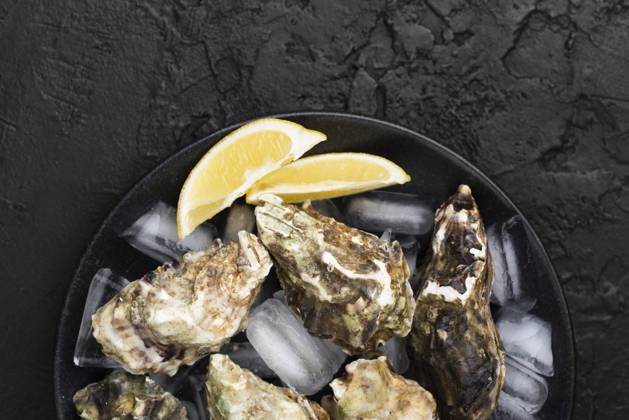 top view plate with oysters lemon slices. High quality and resolution beautiful photo concept top view plate with oysters lemon slices. Resolution and high quality beautiful photo Copyright: xZoonar.com OleksandrxLatkunx 17863235