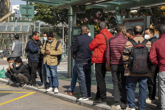 Daily Life In Macau Commuters wearing face masks while waiting for a bus at a bus stop on December 29, 2022 in Macau, China. Macau Macau  Copyright: xVernonxYuenx originalFilename: yuen-dailylif221229_np6tS