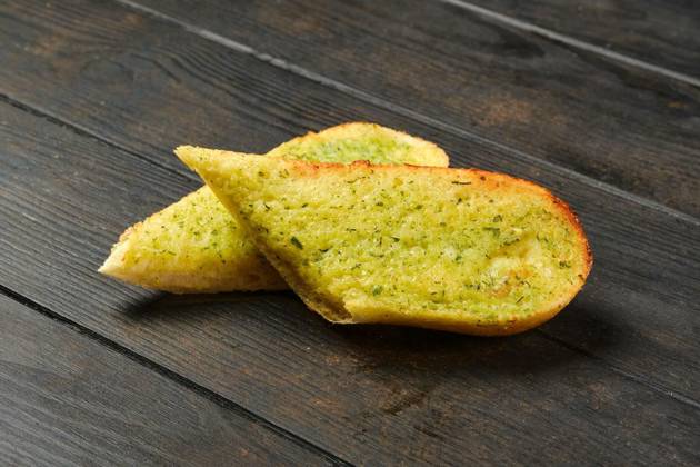 IMAGO Creative, Food, Brot, Knoblauchbrot Two pieces of garlic bread, Two pieces of garlic bread on a table, Two pieces of garlic bread on a table, 20.09.2022, Copyright: xBoomeartx Panthermedia31876687.jpg