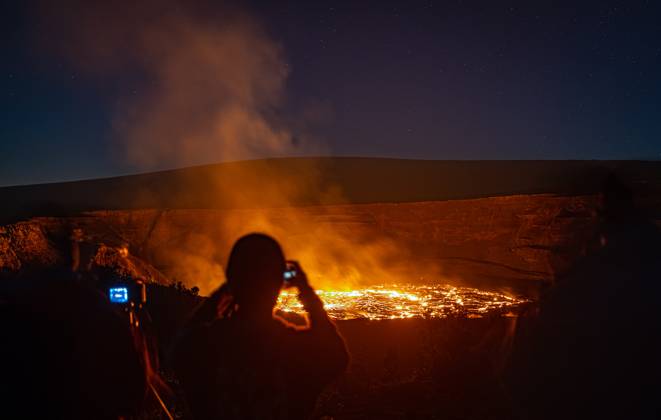 VOLCANO, HI - January 7, 2023: Spectators observe the eruption pictured as Hawaii?s Kilauea volcano eruption continued after re-erupting on January 5th in Volcano, HI on January 7, 2023. Copyright: xErikxKabikxPhotography xMediaPunchx