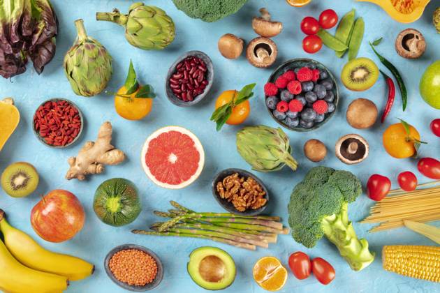 Vegan food. Healthy diet concept. Fruits, vegetables, pasta, nuts, legumes, mushrooms, shot from above on a blue background. A flat lay composition Vegan food. Healthy diet concept. Fruits, vegetables, pasta, nuts, legumes, mushrooms, shot from above on a blue background. A flat lay composition Copyright: xZoonar.com KaterinaxSolovyevax 14755857