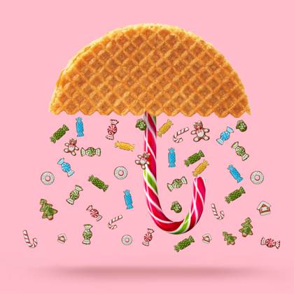 Waffle with caramel Christmas candy and Umbrella made of waffle on a pink background. Copyright: xZoonar.com IaroslavxDanylchenkox 10151139