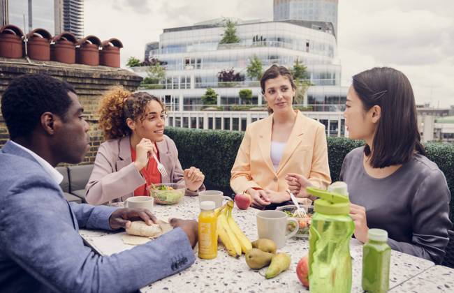 Businesswoman having lunch and talking with colleagues sitting at table model released, Symbolfoto property released, PWF00602