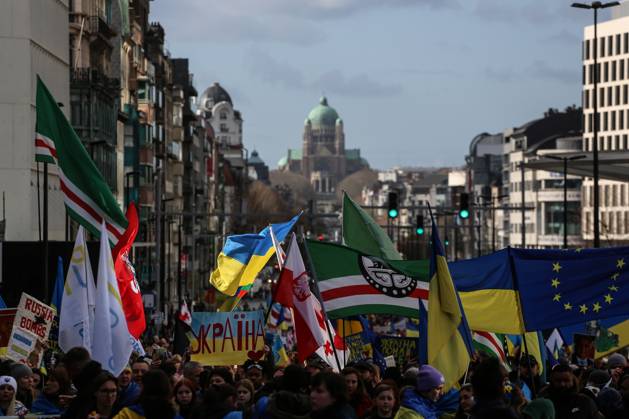 February 25, 2023, Brussels, Brussels Capital Region, Belgium: People hold signs, Ukrainian and Belarusian flags, and flags of the Chechen Republic of Ichkeria during a demonstration in occasion of the one-year anniversary of Russia s invasion of Ukraine in Brussels, Belgium, February 25, 2023. Brussels Belgium - ZUMAm177 20230225_zip_m177_007 Copyright: xValeriaxMongellix