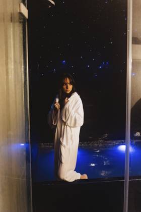 Thoughtful woman wearing bathrobe standing in swimming pool model released, Symbolfoto property released, JJF00117