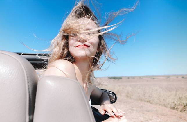 Happy woman sitting on passenger seat in car Joyful young female in summer clothes sitting on passenger seat of cabriolet and looking at camera over shoulder during road trip Copyright: xZoonar.com DashaxPetrenkox 16727850 ,model released, Symbolfoto ,property released