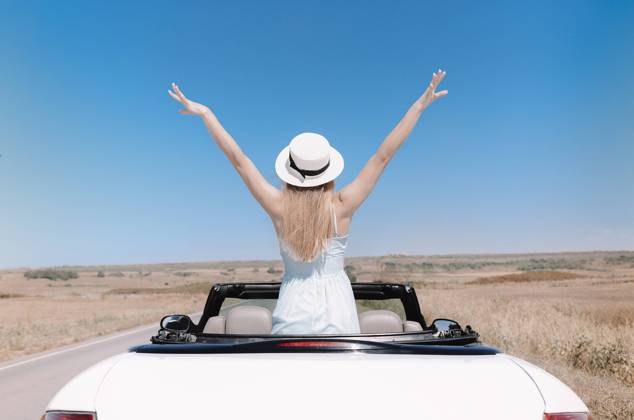 Happy woman sitting on passenger seat in car Back view of joyful young female in summer clothes in cabriolet during road trip Copyright: xZoonar.com DashaxPetrenkox 16727882 ,model released, Symbolfoto ,property released