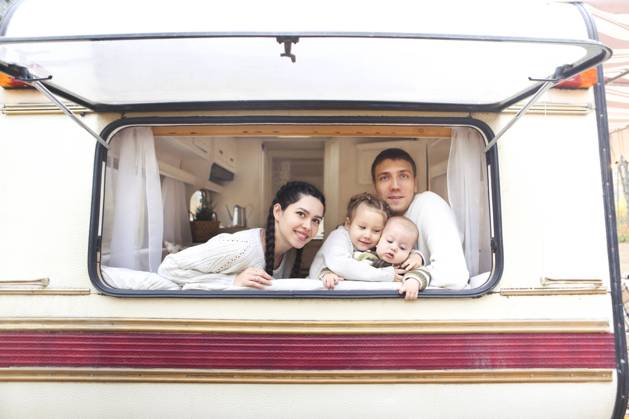 Portrait of the smiling happy family with kids in the house on wheels Portrait of the smiling happy family with kids in the house on wheels indoor ,model released, Symbolfoto Copyright: xZoonar.com DashaxPetrenkox 15607512 ,model released, Symbolfoto ,property released
