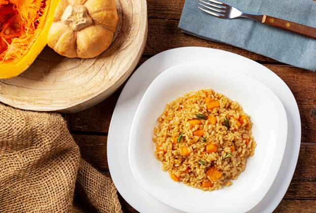 Pumpkin risotto, Recipe with Rice and Pumpkin at rustic Table with Ingredients Recipe for Autumn and Halloween 1085317607