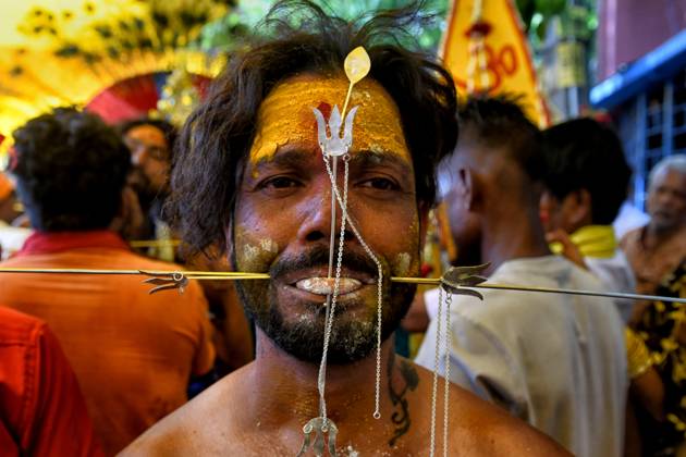 April 6, 2023, Bandel, India: A devotee is seen with their mouth pierced by a vel spear (also known as a divine javelin) during the Vel Vel religious festival in West Bengal. Velvel is a Hindu festival dedicated to the Hindu God Murugan Mutthumariamman and is celebrated in the month of April. Devotees perform different painful rituals, often involving piercing, with a belief that God Murugan Mutthumariamman will save their family members from all evil powers for next one year. Bandel India - ZUMAs197 20230406_zaa_s197_292 Copyright: xAvishekxDasx