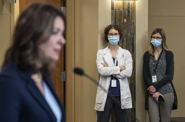 April 11, 2023, SHERWOOD PARK, AB, CANADA: A healthcare worker gives the middle finger as Alberta Premier Danielle Smith announces a public health guarantee in Sherwood Park, Alta., Tuesday, April 11, 2023. SHERWOOD PARK CANADA  - ZUMAc35_ 20230411_zaf_c35_019 Copyright: xJasonxFransonx