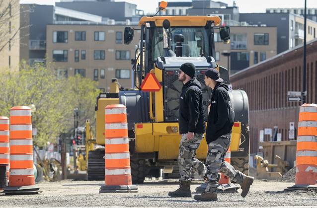 April 25, 2023, Montreal, PQ, Canada: People walk by construction cones in Montreal, Tuesday, April 25, 2023. The Quebec government has vowed to remove the cones after 72 hours of inactivity. Montreal Canada - ZUMAc35_ 20230425_zaf_c35_048 Copyright: xGrahamxHughesx