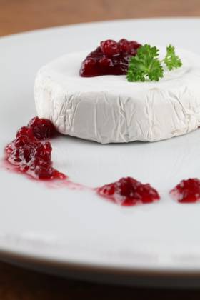 Camembert with cranberry jam and parsley on white plate. Shallow dof Copyright: xIngridxHeczkox xDesignxPicsx , 31116029 Copyright: ElenaxNovikovax xDesignxPics 31116029